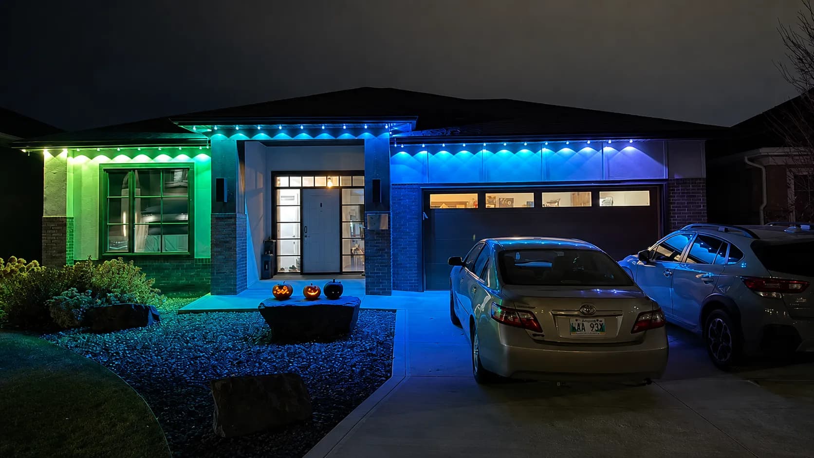 Modern home exterior holiday lighting at night